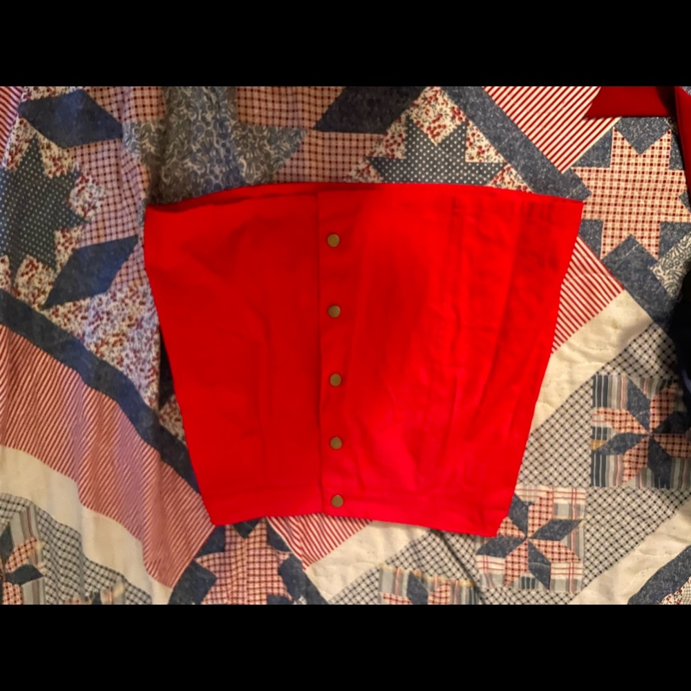 Red skirt that unbuttons in the front, mid-upper thigh